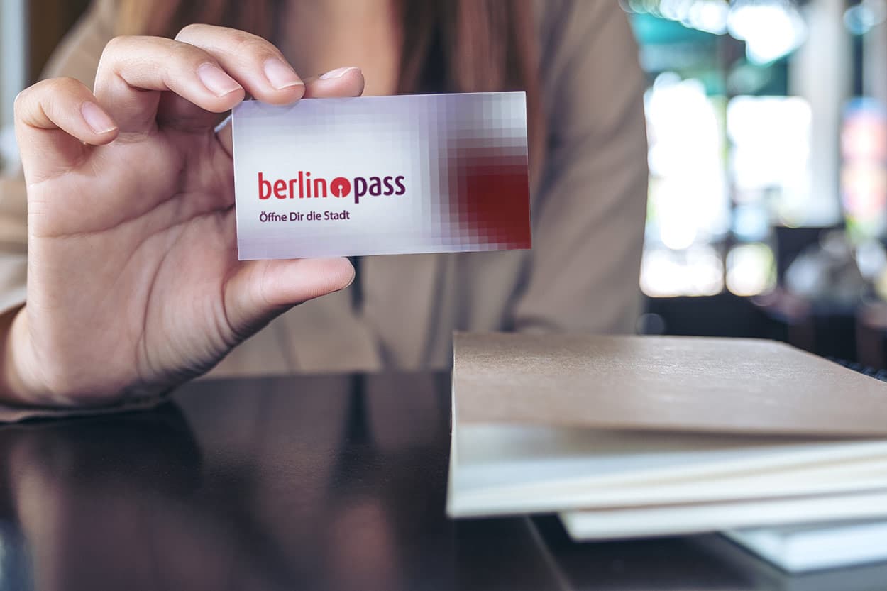 junge Frau mit Berlinpass in der Hand