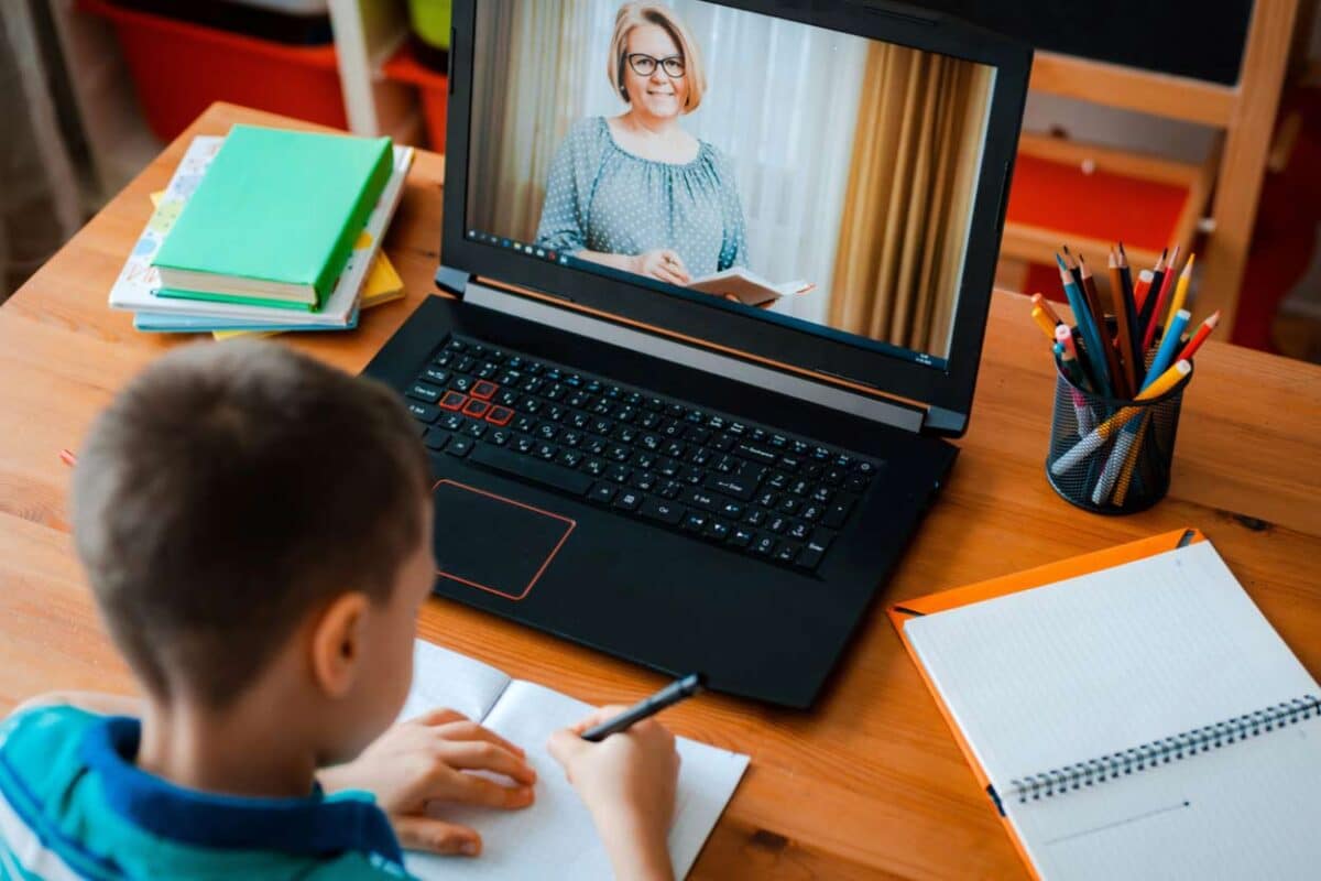 Junge sitzt vor Laptop und lernt