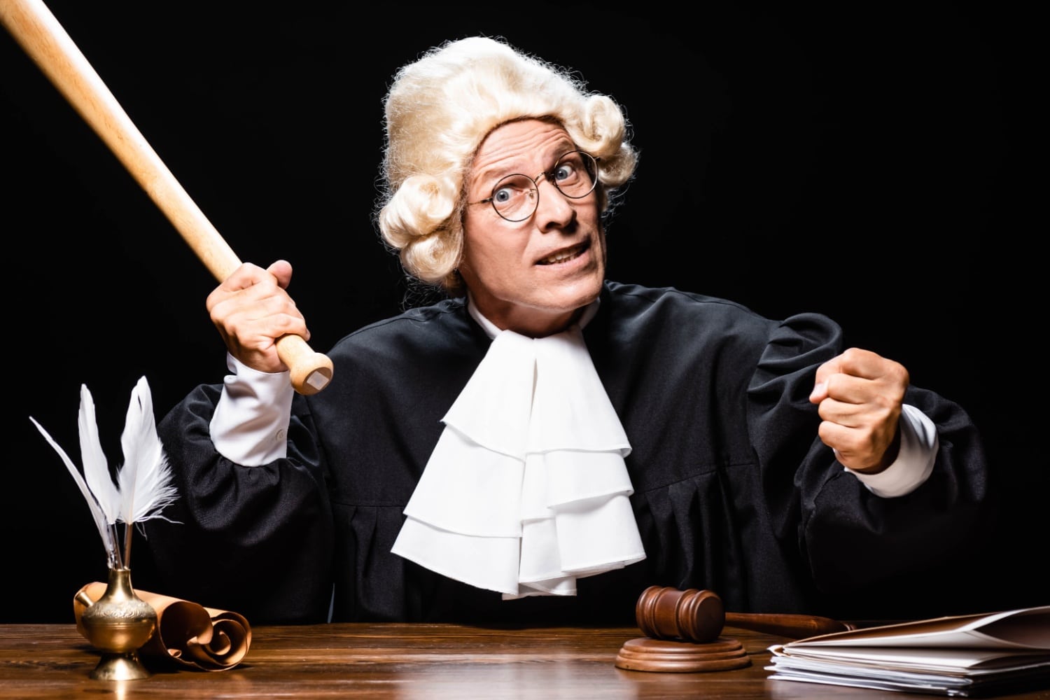 Richter hält demonstrativ einen Knüppel hoch, symbolisch für Kritik / Mahnung des Gerichts