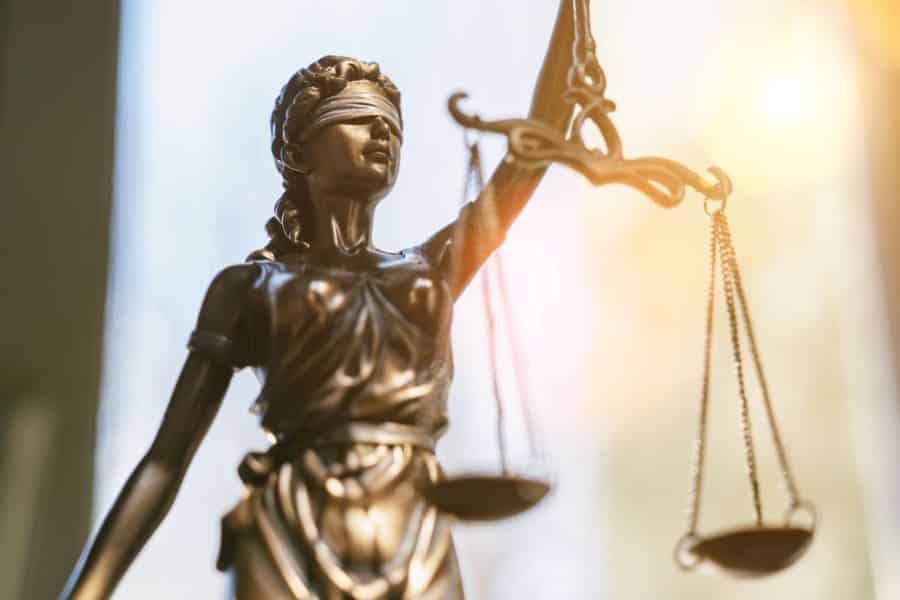 Justitia als Symbol für Urteil über Geschenk für Pilgerfahrt mit Bürgergeld